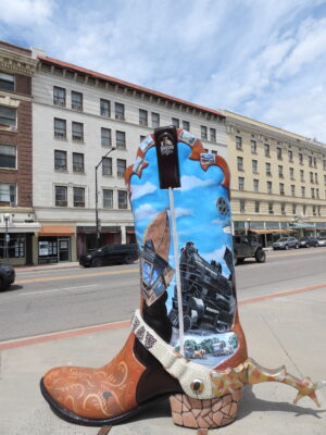 Cowboy boot with train painted on it